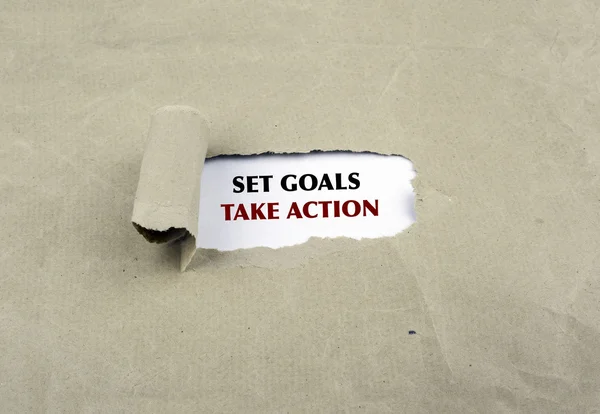 Inscription revealed on old paper - Set Goals, Take Action