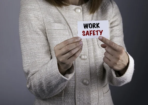Work Safety. Businesswoman holding a card with a message text wr