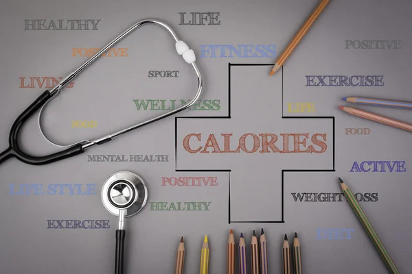 CALORIES word cloud, health cross concept. Colored pencils and a