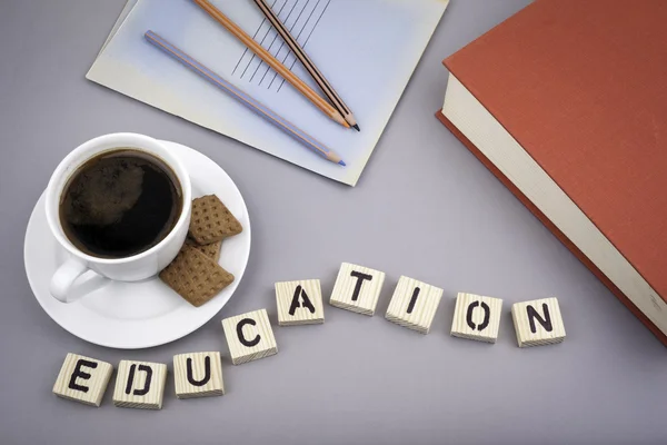 Text: Education from wooden letters on a gray desk