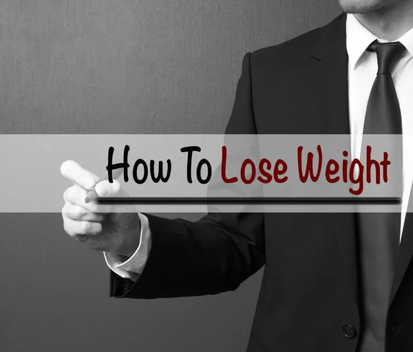 Business man writing: How To Lose Weight