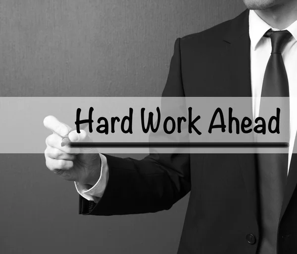 Business man writing: Hard Work Ahead
