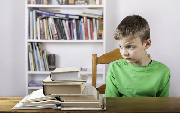 Confused boy student reading book