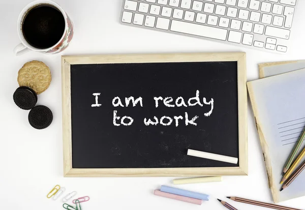 Chalkboard on office desk with text: I am ready to work