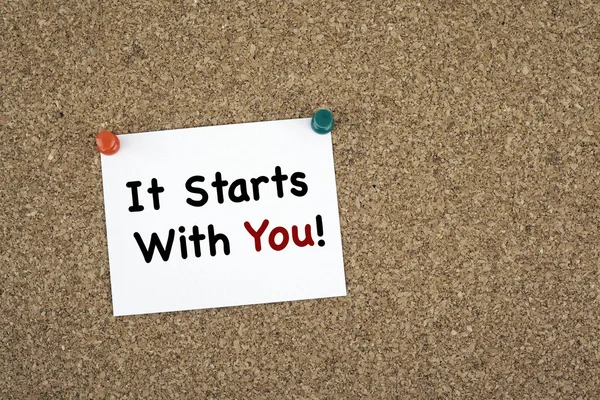 It Starts With You! Sticky note on cork board