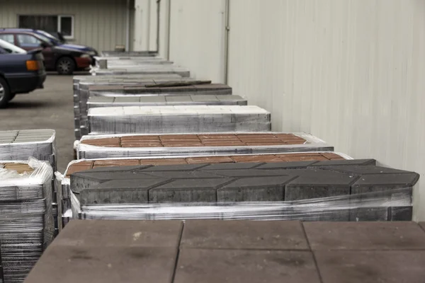 Cobblestone wrapped in plastic paving on wooden pallets