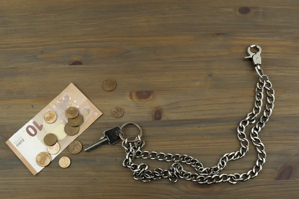 House keys and small change on the wooden table