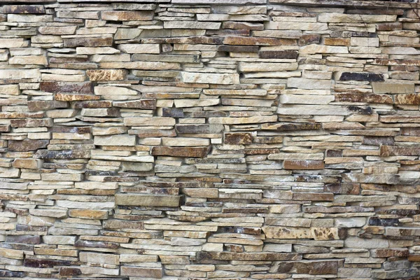 A wall of a wild yellow decorative stone