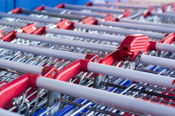 Red pen and receiver supermarket trolley coins stacked together