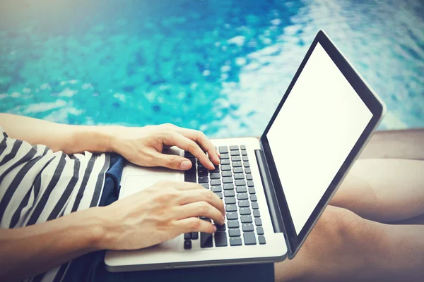 Screen mockup of laptop that a man is using in the pool