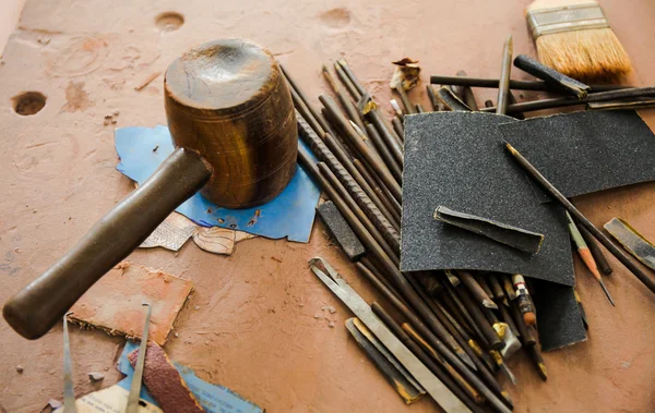 Various kinds of Sculpting Tools laying down on dirty wooden table