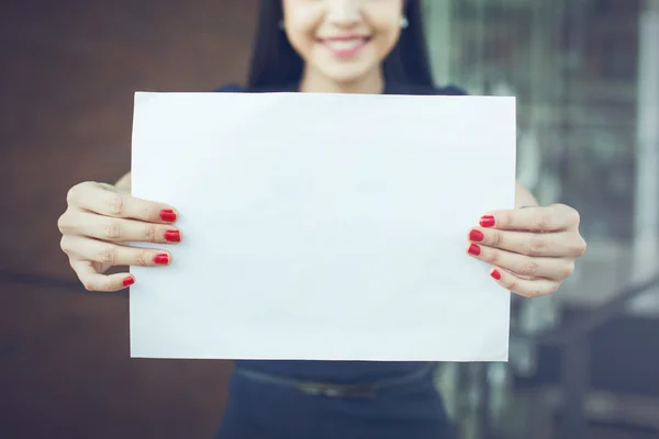 Half face of business woman holding an empty sign