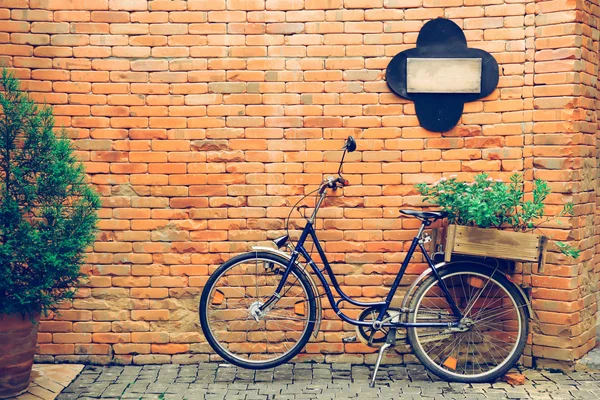 Bicycle with old brick wall in vintage tone with copy space