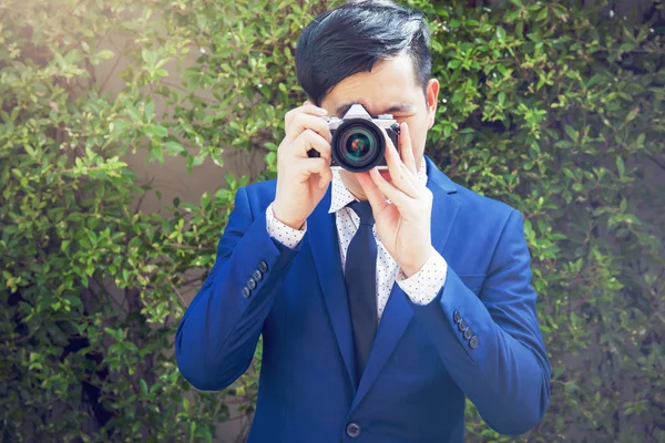 Asian professional photographer take photos in green background