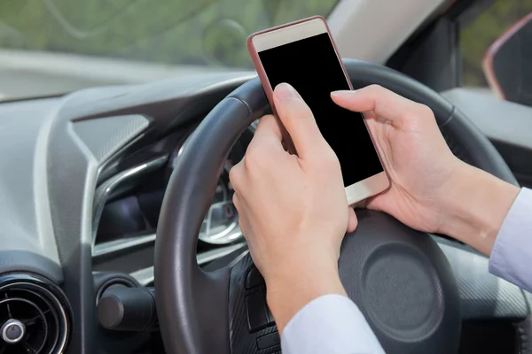 Businessman texting, chatting, playing on phone while careless driving - distraction concept - with clipping mask on screen
