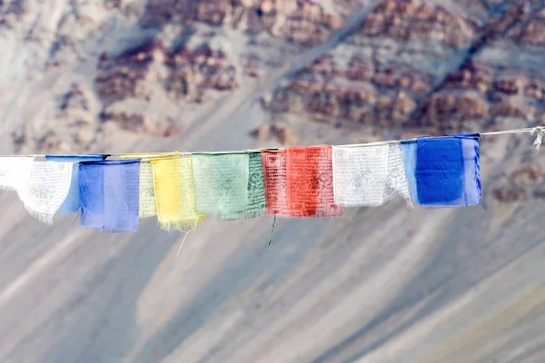 Colorful prayer flags with sun shining through one of prayer flags in Leh, Ladakh, India.