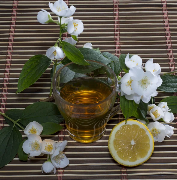 The tea decorated with branches of the blossoming bush