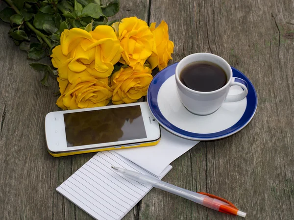 Cup of coffee, bouquet of yellow roses, phone, the handle, the t