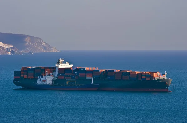 Bunkering tanker Vitaly Vanyhin a large container ship Mataquito anchored in the roads. Nakhodka Bay. East (Japan) Sea. 02.03.2015