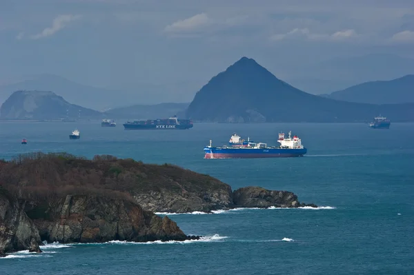 Tanker moving across the bay past the headland. Nakhodka Bay. East (Japan) Sea. 05.05.2014