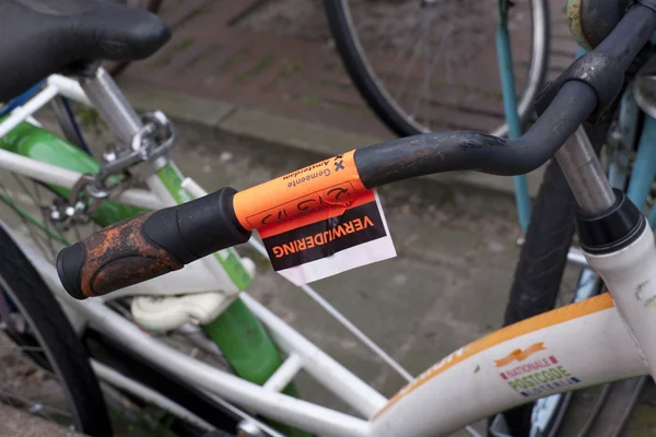 Cycling inconvenience, remove sticker on bike in downtown Amster
