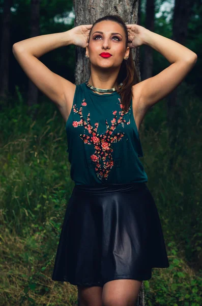 Portrait of young,  elegant woman  in the forest