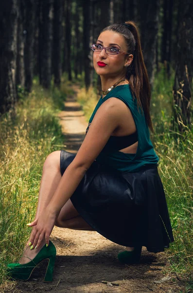 Portrait of young,  elegant woman  in the forest
