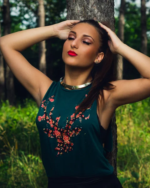 Portrait of young,  elegant woman  in the forest