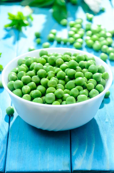 RAW baby peas in small white bowl