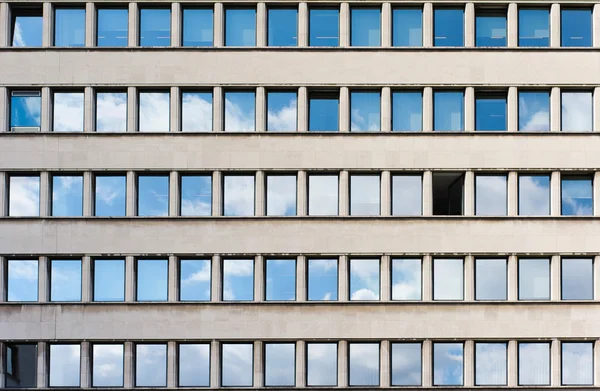 Facade of office building with sky reflection