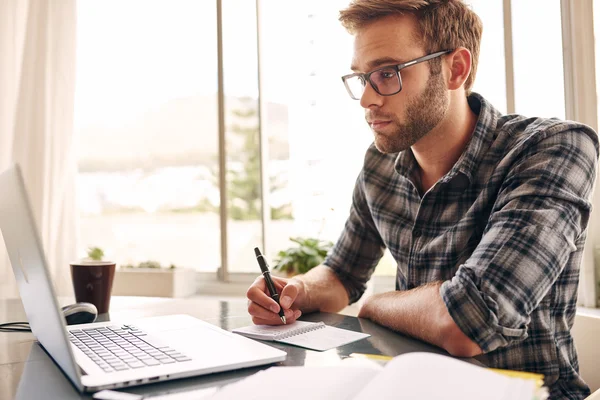 Young adult writer looking at his notebook screen