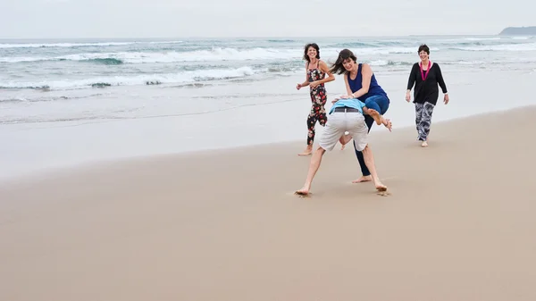 Family being playful together on the beach