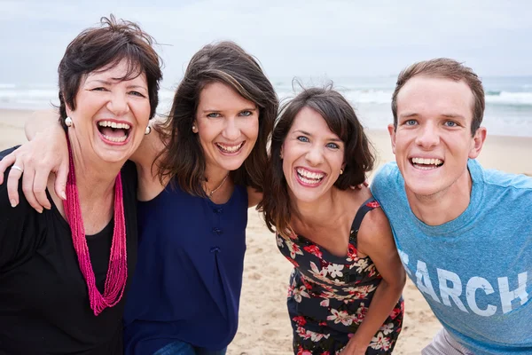 Family laughing and having fun on the beach together