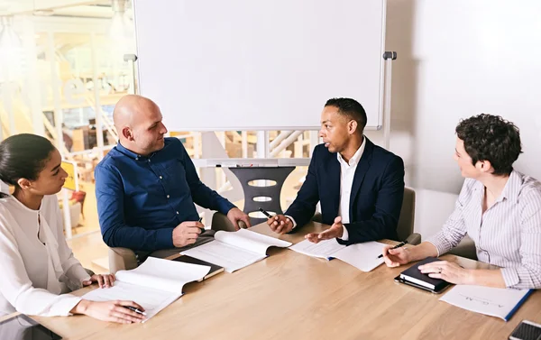 Business meeting between 4 unique individuals