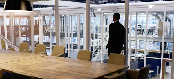 Businessman standing in empty conference room