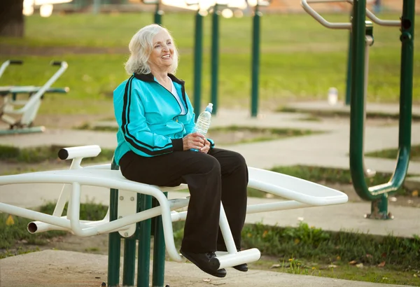 Senior Woman Resting after Exercises Outdoors