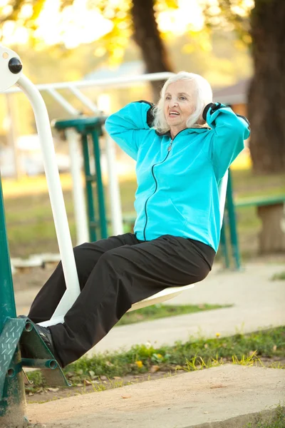 Senior Woman doing Exercises Outdoors