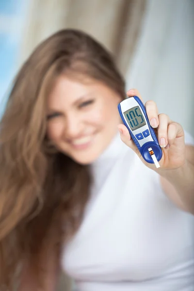 Female Diabetic Doing a Glucose Level Finger Blood Test