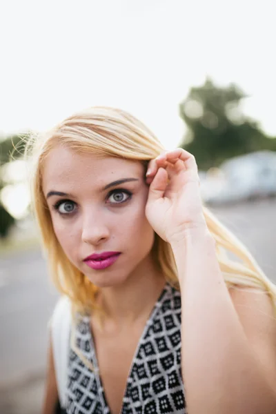 Portrait of young blonde woman in nature