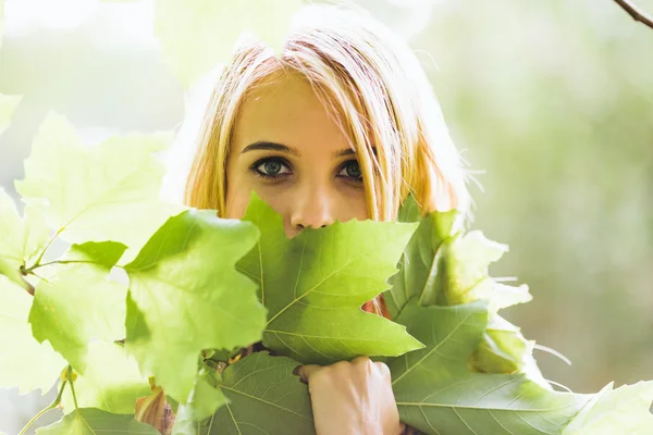 Portrait of young blonde woman in nature