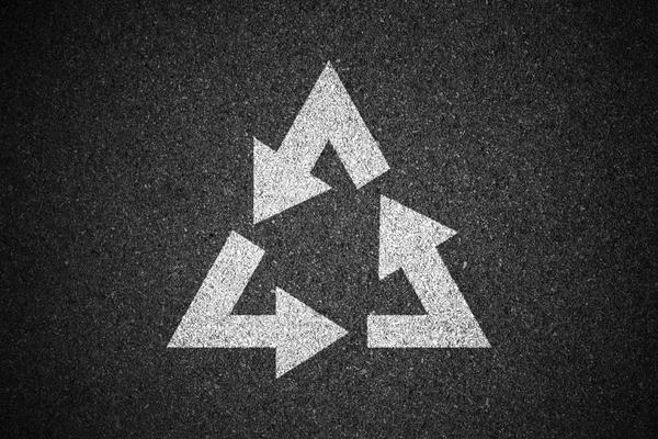 Recycling symbol sign on asphalt