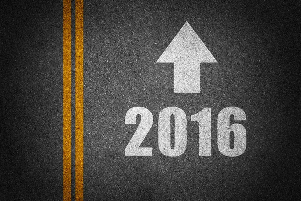 New year with arrow sign on asphalt