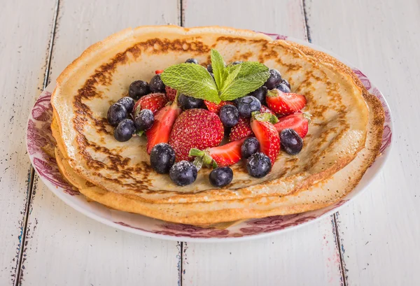 Homemade crepes with berries and fruit