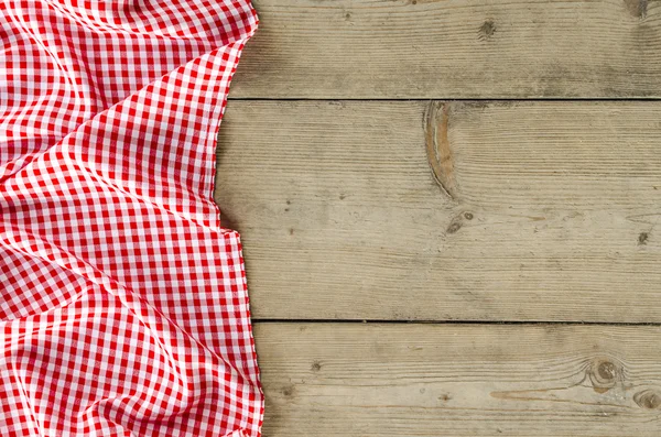 Red folded tablecloth over wooden table