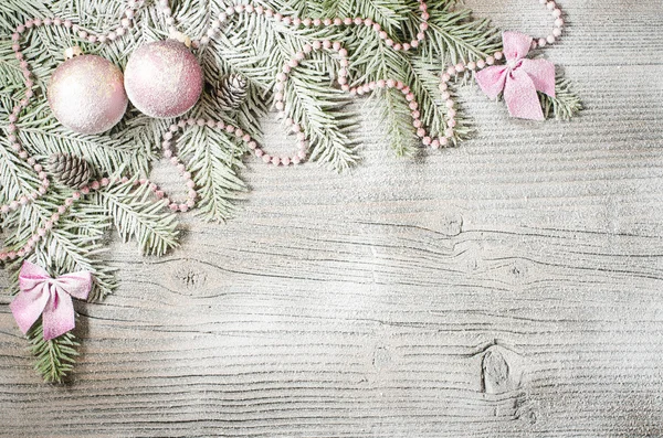 Christmas tree with decoration over old wooden background