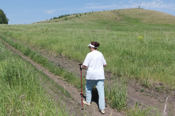 Nordic Walking - elderly woman is hiking