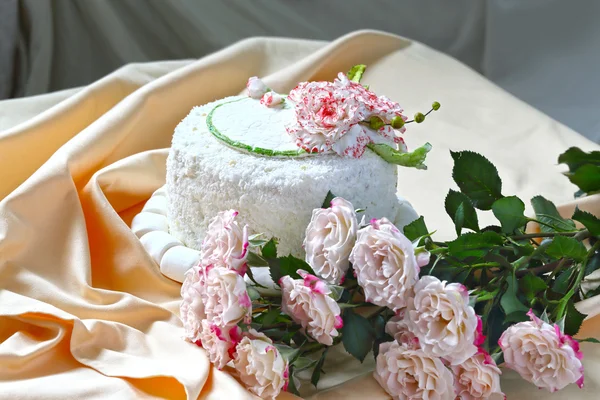 Celebratory cake decorated with marzipan roses and ivy leaves