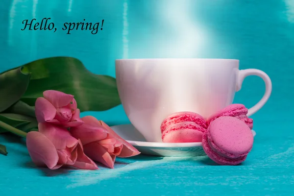 Tag hello spring, pink tulips, cup of coffee and pink macaroons