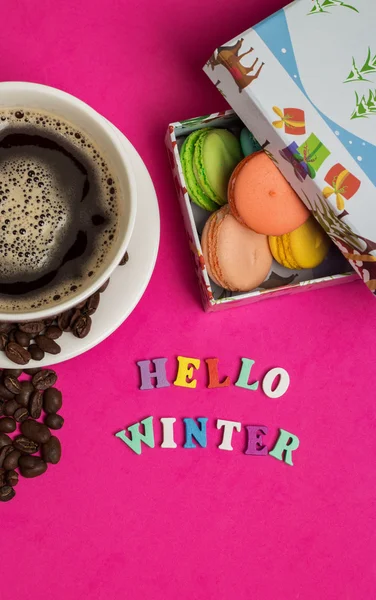 Tag hello winter, cup of coffee with macaroons