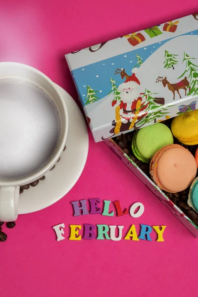 Tag hello february, cup of coffee with macaroons